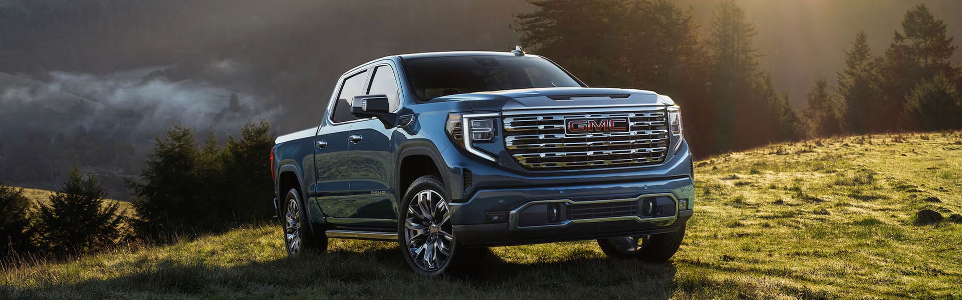 GMC Sierra 1500 parked on grassy hillside